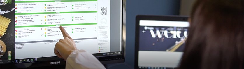 a woman pointing to a computer screen